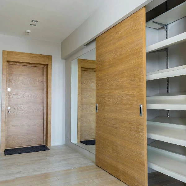 Light wooden-effect vinyl wrap on a sliding door